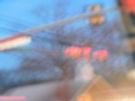 A slightly blurred image of street lights on an intersection with a blurry affect
