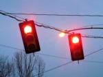 Street lights against a blue cloudly sky